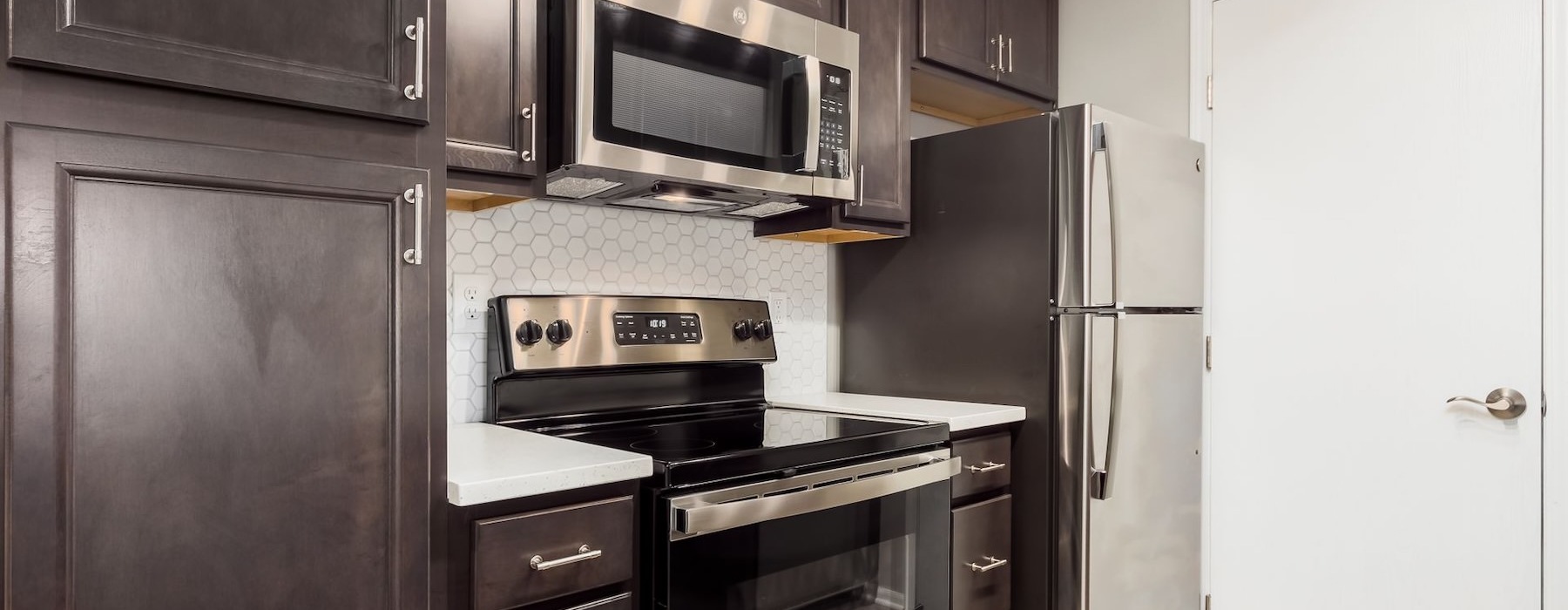 a kitchen with dark cabinets